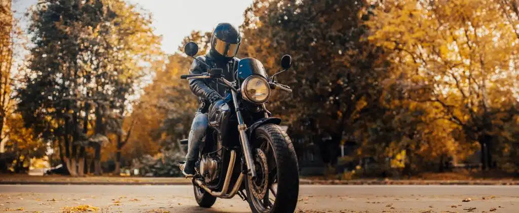 A man in leather on a motorcycle