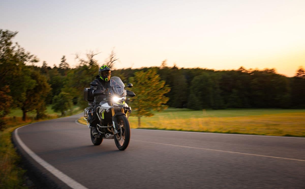 A motorcyclist in a wooded area